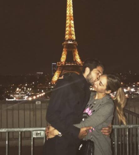 Karim Ansarifard kissing his wife Alexandra-Sofia Kalouli in front of Tokyo tower.